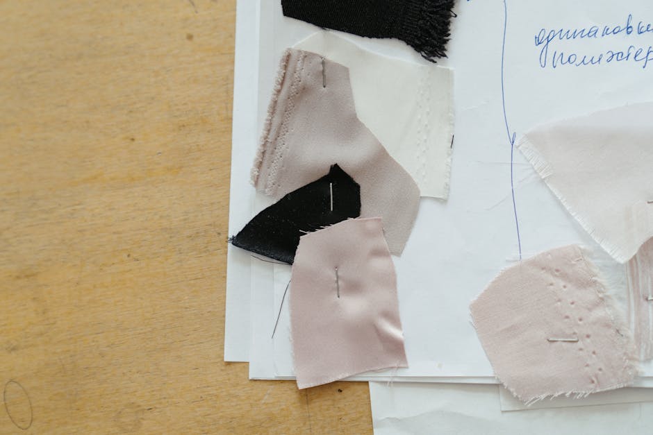 A collection of fabric swatches pinned on paper, ideal for crafting and textile designs.