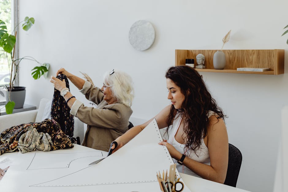 A grandmother and granddaughter sewing together, combining tradition and creativity in a modern studio.